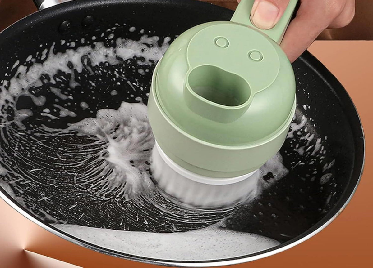 SnapPrep brush head scrubbing a soapy frying pan